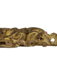 Close-up of gold and brown wooden temple carving featuring intricate, stylized dragon design.