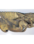 Gold wood bird carving with elaborate wings, antique Chinese temple art, mounted on white background, close-up view.