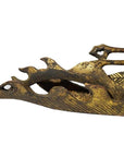 Close-up of brass dragon temple carving with weathered gold finish on white background.