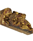 Close-up of gilded wood Chinese temple carving with gold and red floral and leaf patterns.