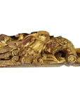 Close-up of gold and red wooden bird sculpture with ornate swirling patterns, antique Chinese temple carving.