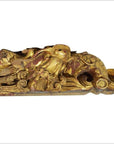 Close-up of gold and red wooden bird sculpture with ornate swirling patterns, antique Chinese temple carving.