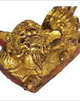 Close-up of dragon-shaped antique Chinese temple carvings, carved wood, pair on rectangular bases against white background.