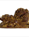Close-up of antique Chinese wood temple carvings with intricate dragon shapes and fierce expressions, side by side.