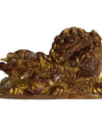 Close-up of antique Chinese wood temple carvings with intricate dragon shapes and fierce expressions, side by side.