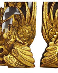 Close-up of ornate gold-painted wood Chinese temple carvings with intricate bird and floral designs.