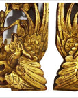 Close-up of ornate gold-painted wood Chinese temple carvings with intricate bird and floral designs.