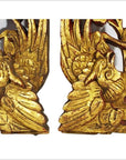 Gold wood Chinese temple carvings, pair of mythical birds with open beaks on plain white background, close-up view.
