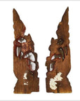 Brown wood antique Chinese temple carvings with pointed tops, decorative cutouts, and subtle white markings.