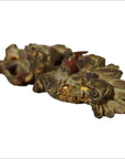 Pair of antique Chinese wooden temple carvings with ornate floral and leaf designs, close-up from below.