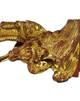 Gold-painted wood carvings, pair of winged mythical creatures with feather and scale details, antique style.