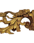 Gold and red wood antique Chinese temple carvings with intricate leaf and scroll patterns, close-up view.