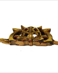 Close-up of golden antique Chinese temple carvings, ornate with pointed ends and round filigree centers.
