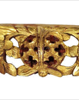 Gold wood Chinese temple carvings with ornate floral motifs, round pierced centers, and detailed leaf designs, close-up.