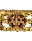 Gold wood Chinese temple carvings with ornate floral motifs, round pierced centers, and detailed leaf designs, close-up.