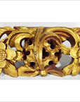 Brown wood temple carvings with floral motifs, intricate patterns, and central round accent, side by side indoors.