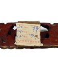 Red wood antique Chinese temple carvings with worn paper label, handwritten numbers, and Chinese text.