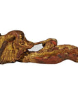 Close-up of ornate gold and red wood Chinese temple carvings featuring stylized animal head designs.