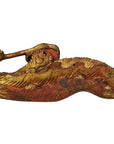 Close-up of ornate gold and red wood Chinese temple carvings pair with intricate curved edges.