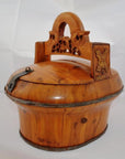Brown wood Chinese wedding basket with carved handle, hinged lid, and metal rim accents on white background.