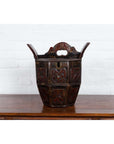 Brown wood wedding box with carved handle, animal and foliage motifs, on a table.