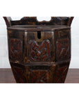 Close-up of a brown antique Chinese wedding box with carved handle, animal and foliage motifs, wood material.