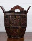 Brown wood Chinese wedding box with carved handle, animal and foliage motifs, shown indoors against a white wall.