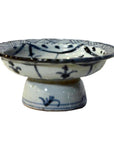 Close-up of a white and blue porcelain footed rice bowl with floral patterns, vintage style, on a white background.