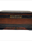 Close-up of antique Chinese wood and rattan box with dark trim and metal lock plate on the front.