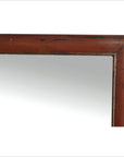 Close-up of the top right corner of a reddish-brown wooden framed Antique Classic Mirror.
