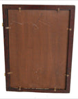 Close-up of visible clips securing the brown backing board on the reverse side of an antique classic mirror.