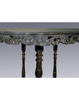Dark wood antique demi lune table with carved floral accents and three turned legs, shown on a plain background.