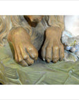 Close-up of beige stone European statue, antique style, detailed surface texture visible.
