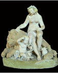 White stone statue of woman, child, lion, and sheep on pedestal inscribed THE GOLDEN AGE, close-up view.