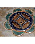 Green, blue, and brown glazed ceramic Annamese garden seat or side table with floral pattern and center hole.