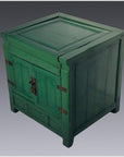 Green lacquer antique cabinet with double doors, metal hinges, and lock, set against a plain gray background.