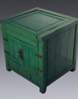 Green lacquer antique cabinet with double doors, metal hinges, and lock, set against a plain gray background.
