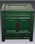 Antique green lacquer cabinet with two doors and metal hinges, set against a plain gray background.