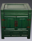 Antique green lacquer cabinet with two doors and metal hinges, set against a plain gray background.