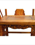 Close-up of brown hand-carved lacquered elmwood chair with cane seat, antique 19th century Chinese style.