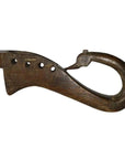 Close-up of a brown hand carved wooden Indian lute with four holes and a hook-shaped end on white background.