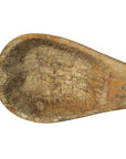 Brown wood hand-carved Indian lute with scallop shell design and detailed ridges, close-up of natural texture.