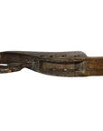 Close-up of a weathered wooden Indian lute with a curved, looped end and rustic details.