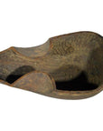 Close-up of a weathered wood hand-carved antique Indian lute or sitar with rustic, worn details.