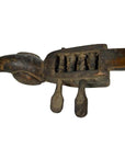 Brown wooden hand-carved Indian lute or sitar with animal head design, two tuning pegs, and visible strings, close-up.