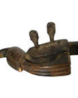 Brown hand carved wooden Indian sitar with two vertical projections against a plain white background.