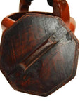 Close-up of a red lacquered wood Chinese wedding basket with carved handle and worn finish.