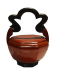 Red lacquered hand-carved wooden Chinese wedding basket with cloud-shaped handle, front view on white background.