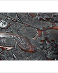 Close-up of antique hand-carved lacquered rosewood wall plaque with bird, branch, flowers, and detailed foliage.