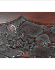 Close-up of dark rosewood wall plaque, hand-carved with lacquered finish and detailed 19th century Chinese floral relief.